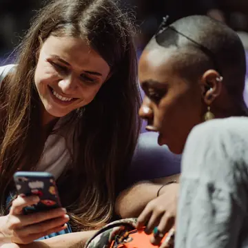 Two friends laughing at a phone